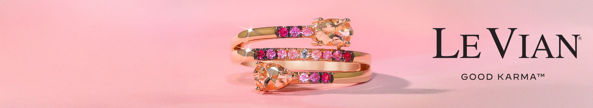 A Le Vian Good Karma Ring with Pink Morganite, Sapphire, Yellow Gold and a twist style, part of a jewelry collection.
